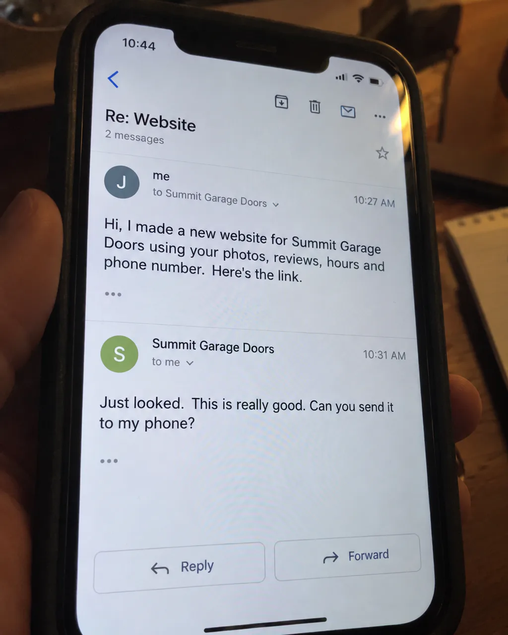 Candid phone photo showing the Summit Garage Doors email thread and timestamps